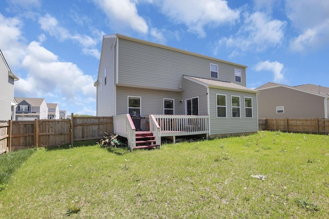 back of house featuring a lawn, a fenced backyard, and a deck