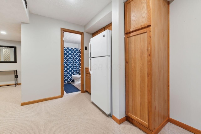 81 Highmeadows Cir, Powell, OH 43065 - kitchen with light colored carpet, freestanding refrigerator, and baseboards