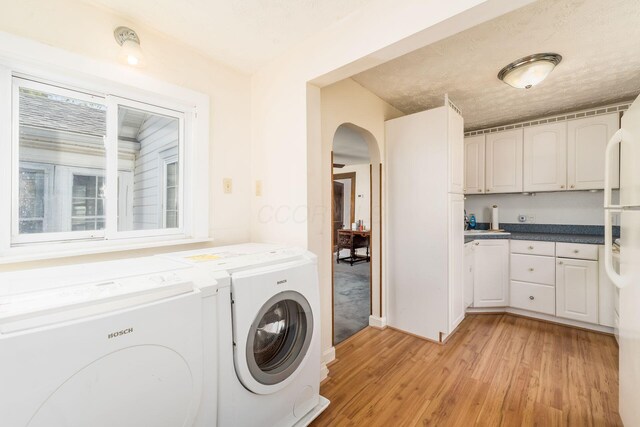 2953 Atwood Ter, Columbus, OH 43224 - laundry room with light wood-style flooring, arched walkways, independent washer and dryer, and laundry area