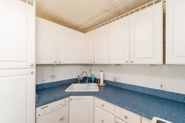 2953 Atwood Ter, Columbus, OH 43224 - kitchen featuring a textured ceiling, white cabinetry, a sink, dark countertops, and dishwasher