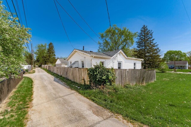 2953 Atwood Ter, Columbus, OH 43224 - view of side of home featuring fence, concrete driveway, and a yard
