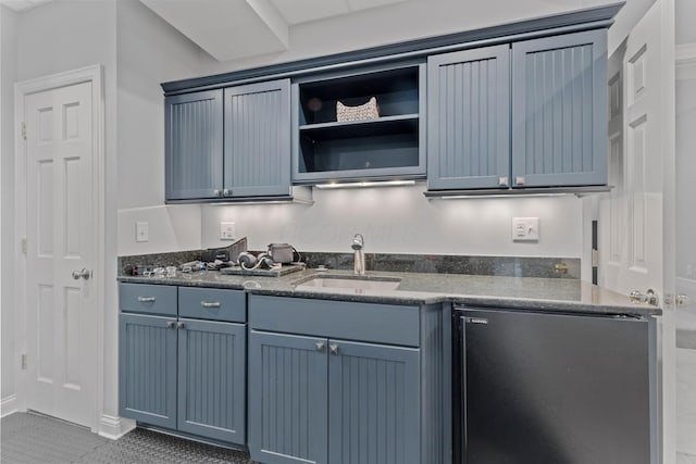 660 Woods Hollow Ln, Powell, OH 43065 - kitchen with a sink, dark stone countertops, open shelves, blue cabinetry, and tile patterned flooring