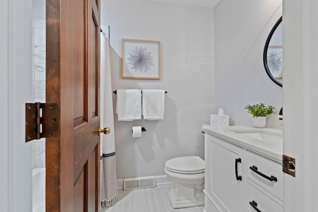 660 Woods Hollow Ln, Powell, OH 43065 - half bath with baseboards, visible vents, toilet, and vanity