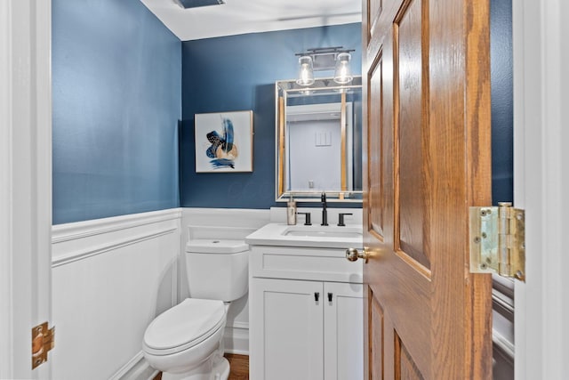 660 Woods Hollow Ln, Powell, OH 43065 - bathroom featuring toilet, wainscoting, and vanity
