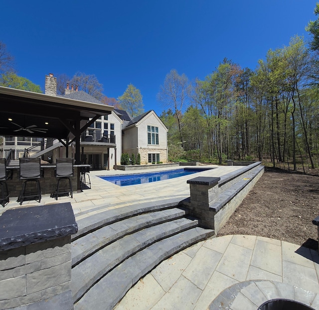660 Woods Hollow Ln, Powell, OH 43065 - outdoor pool featuring outdoor dry bar, a patio, and ceiling fan