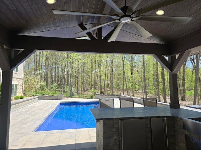 660 Woods Hollow Ln, Powell, OH 43065 - outdoor pool with ceiling fan, a patio area, a forest view, and outdoor wet bar