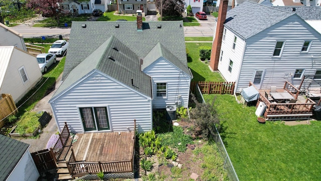 264 Merchant Ave, Marion, OH 43302 - rear view of house featuring a residential view, a deck, a fenced backyard, central air condition unit, and a yard