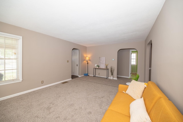 264 Merchant Ave, Marion, OH 43302 - living room featuring arched walkways, baseboards, carpet, and visible vents