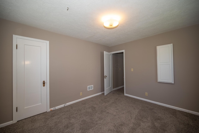 264 Merchant Ave, Marion, OH 43302 - unfurnished bedroom with carpet flooring, a textured ceiling, and baseboards