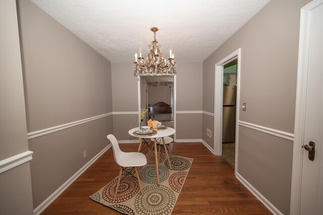 264 Merchant Ave, Marion, OH 43302 - dining room with baseboards, a textured ceiling, wood finished floors, and a chandelier