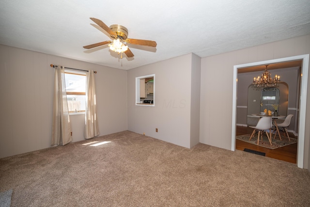264 Merchant Ave, Marion, OH 43302 - carpeted empty room with visible vents and ceiling fan with notable chandelier