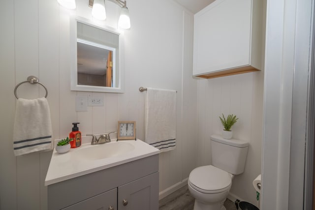 264 Merchant Ave, Marion, OH 43302 - half bath with vanity, baseboards, wood finished floors, and toilet