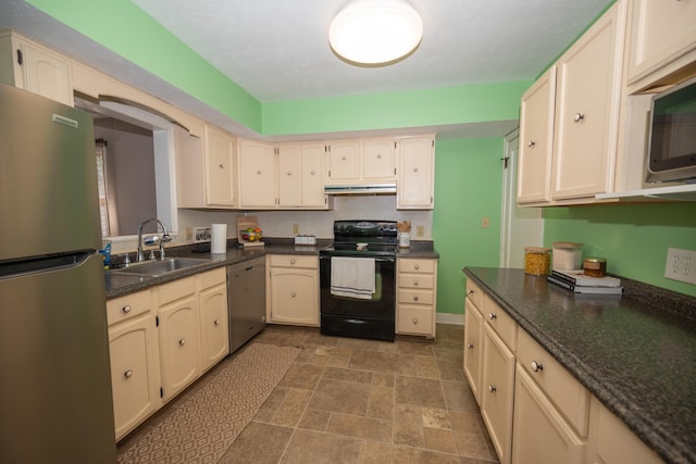 264 Merchant Ave, Marion, OH 43302 - kitchen with dark countertops, a sink, stone finish floor, stainless steel appliances, and under cabinet range hood