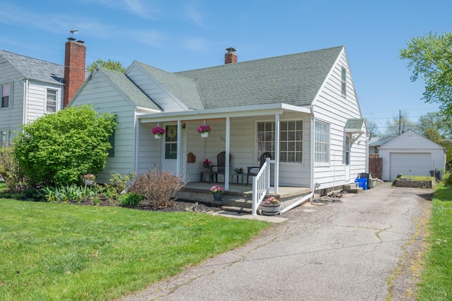 264 Merchant Ave, Marion, OH 43302 - view of front of house featuring a porch, an outdoor structure, a front lawn, and a detached garage