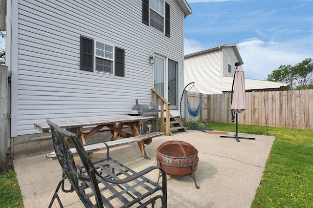 view of patio / terrace with a fenced backyard, a fire pit, and entry steps