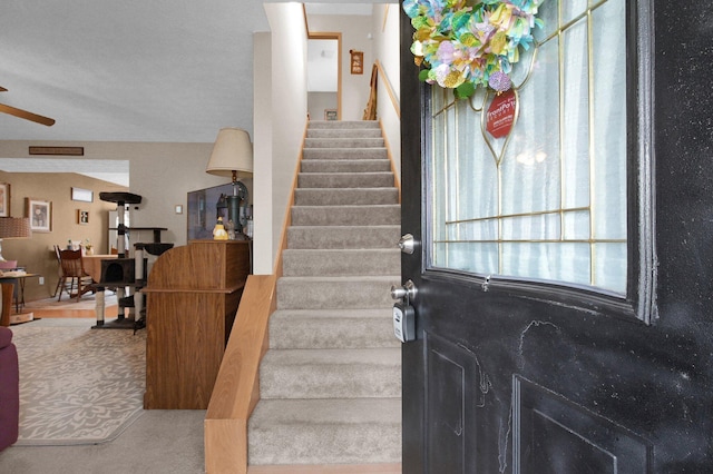 stairs with a ceiling fan