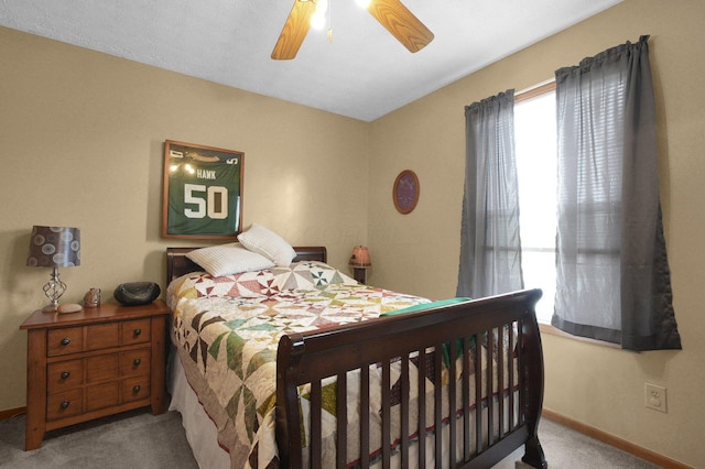bedroom featuring baseboards, a ceiling fan, and carpet flooring
