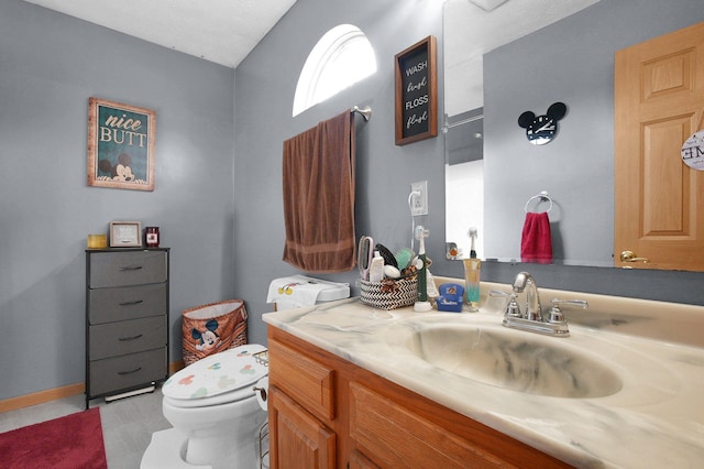 half bathroom with toilet and vanity
