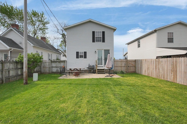 back of house with a lawn, a fenced backyard, a patio area, and entry steps