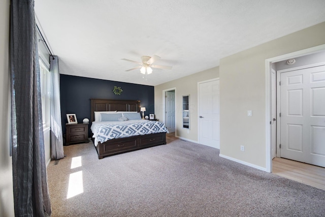 carpeted bedroom featuring baseboards and ceiling fan