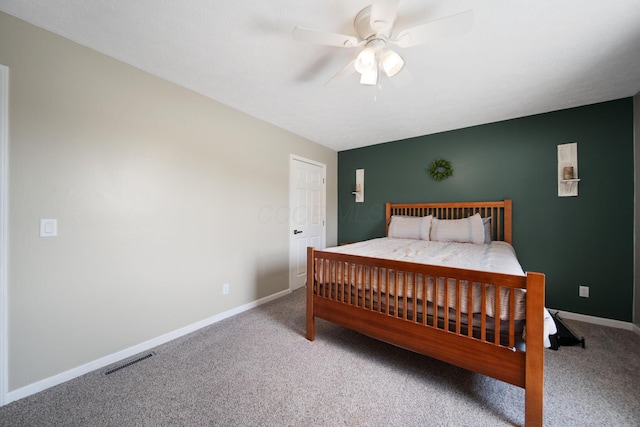 bedroom with visible vents, carpet flooring, and baseboards