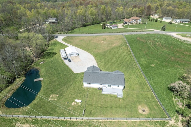 birds eye view of property with a water view and a forest view