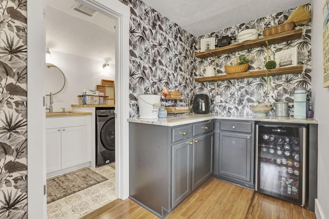 6495 Julian Rd SW, Amanda, OH 43102 - bar with a sink, wallpapered walls, washer / dryer, wine cooler, and indoor bar