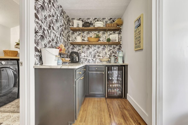 6495 Julian Rd SW, Amanda, OH 43102 - bar featuring light wood-style floors, a textured ceiling, wet bar, washer / dryer, and wine cooler