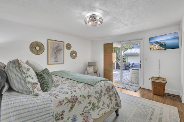 6495 Julian Rd SW, Amanda, OH 43102 - bedroom featuring a textured ceiling, visible vents, access to exterior, wood finished floors, and baseboards