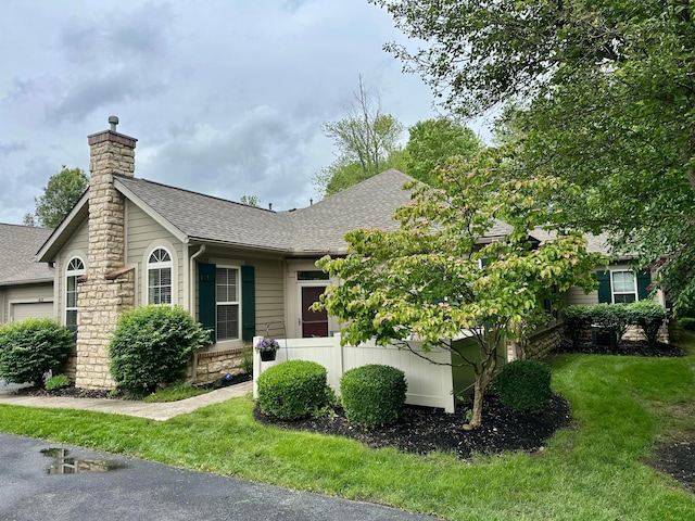 651 Albion Pl, Westerville, OH 43082 - view of front of house featuring a shingled roof, a chimney, a garage, a front lawn, and stone siding