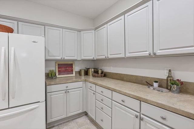 651 Albion Pl, Westerville, OH 43082 - kitchen with freestanding refrigerator, white cabinetry, and light countertops