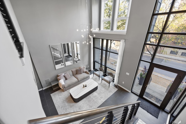 entryway with baseboards and a towering ceiling