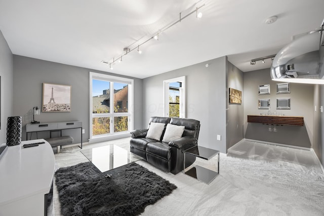 living room featuring track lighting and baseboards