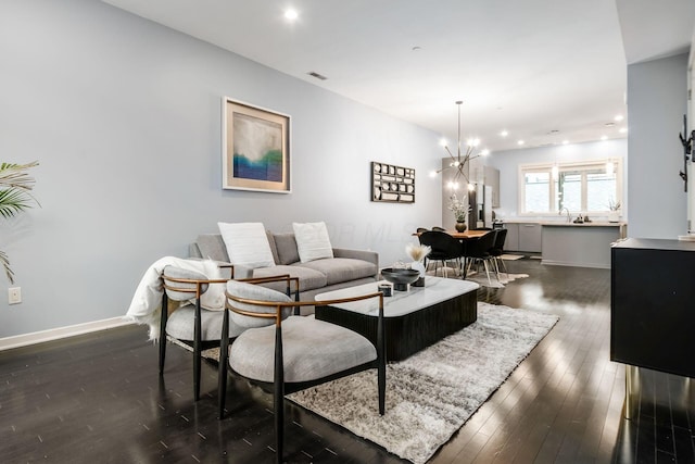 living room with visible vents, dark wood finished floors, baseboards, a chandelier, and recessed lighting