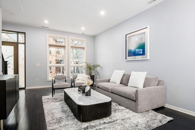 living room featuring baseboards, dark wood finished floors, and plenty of natural light