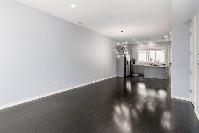 interior space featuring visible vents, baseboards, dark wood-style floors, a chandelier, and recessed lighting