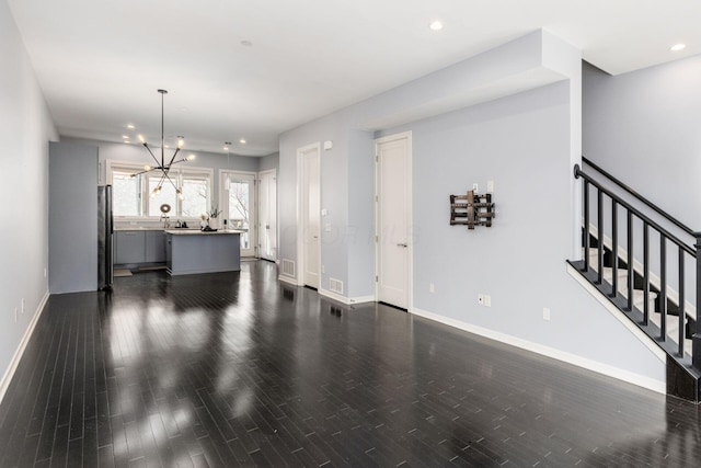 interior space featuring baseboards, recessed lighting, dark wood-style flooring, and stairway