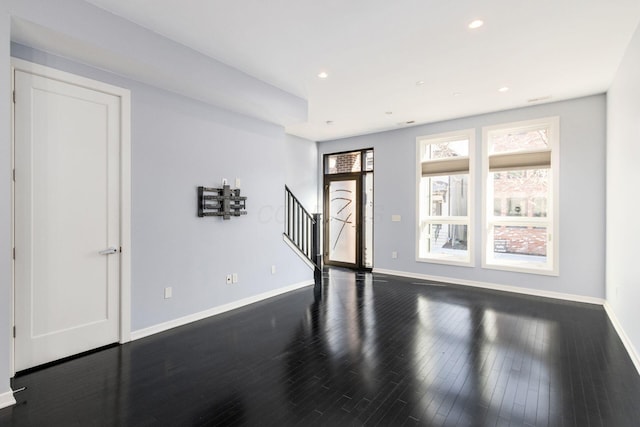 entrance foyer with recessed lighting, baseboards, dark wood-style flooring, and stairs