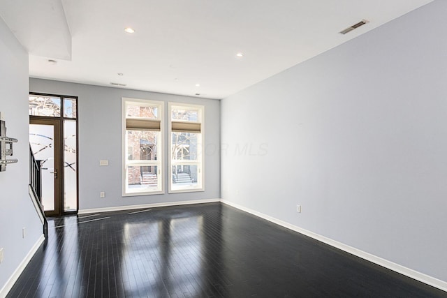 unfurnished living room with recessed lighting, baseboards, visible vents, and dark wood-style floors