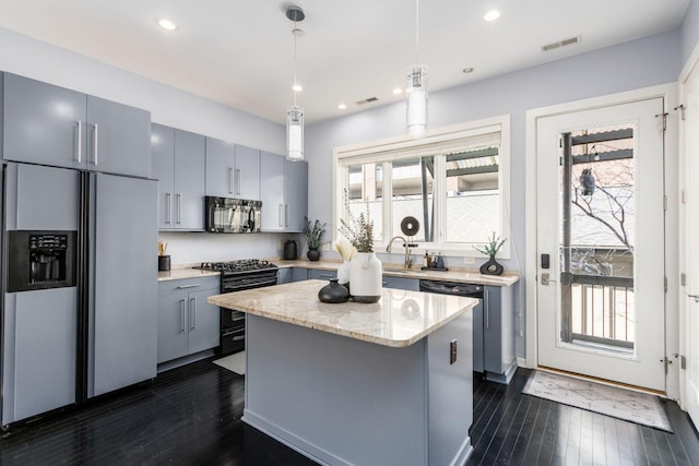 kitchen featuring gray cabinets, black appliances, dark wood-style flooring, and visible vents