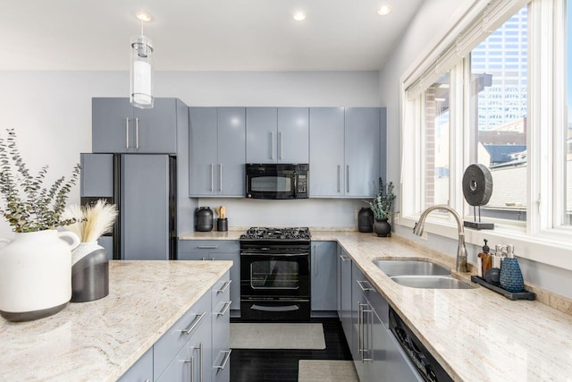 kitchen with hanging light fixtures, a sink, gray cabinets, recessed lighting, and black appliances