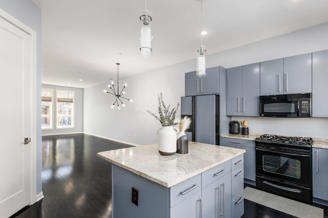kitchen with a center island, gray cabinets, dark wood finished floors, black appliances, and hanging light fixtures