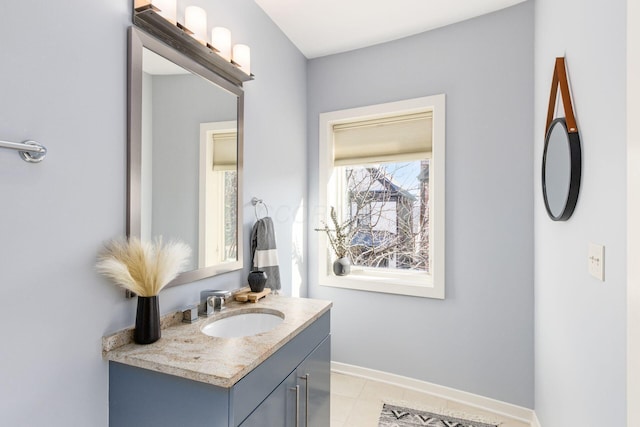 bathroom featuring baseboards, tile patterned flooring, and vanity