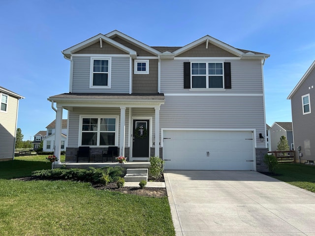 craftsman-style house featuring a front yard, driveway, an attached garage, and covered porch