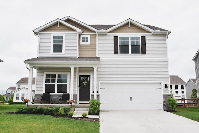 1151 Gelbray Dr, Columbus, OH 43207 - craftsman-style house featuring an attached garage, a front lawn, stone siding, concrete driveway, and covered porch