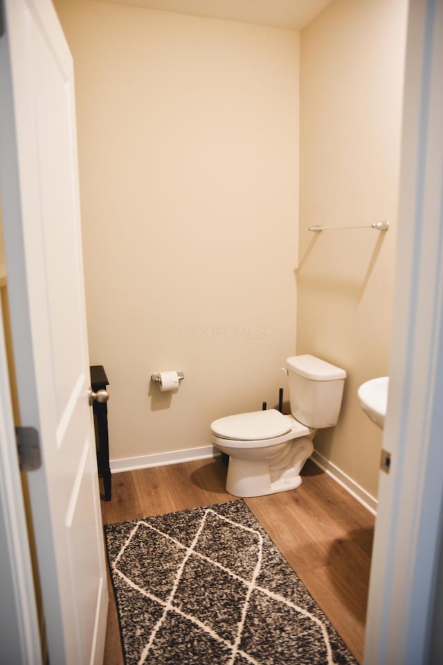 1151 Gelbray Dr, Columbus, OH 43207 - bathroom featuring baseboards, toilet, and wood finished floors