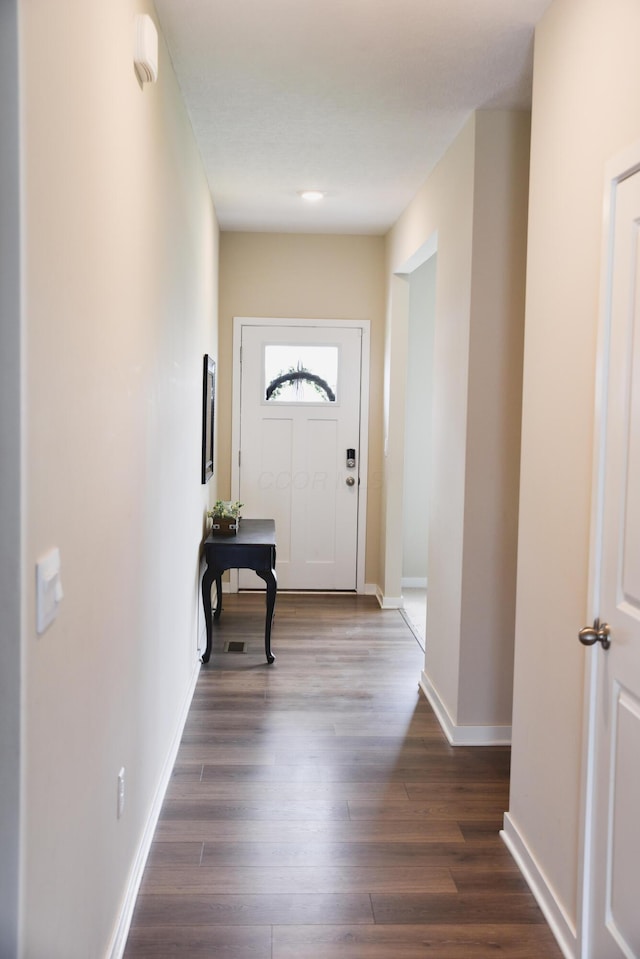 1151 Gelbray Dr, Columbus, OH 43207 - doorway with baseboards and dark wood-style floors