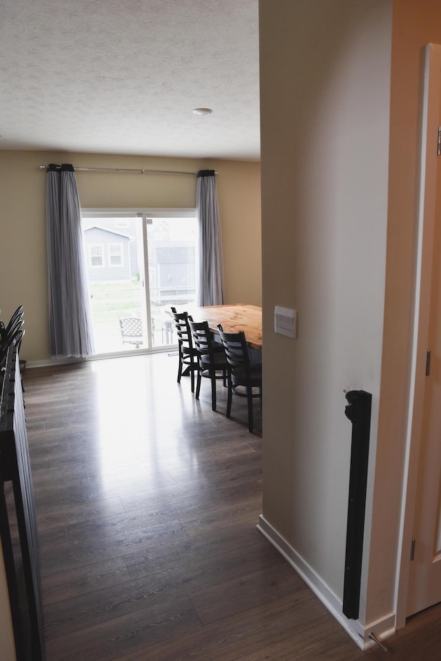 1151 Gelbray Dr, Columbus, OH 43207 - hallway featuring baseboards, a textured ceiling, and dark wood finished floors