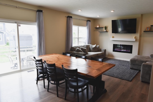 1151 Gelbray Dr, Columbus, OH 43207 - dining area featuring visible vents, recessed lighting, a glass covered fireplace, and wood finished floors