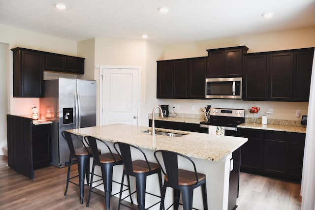 1151 Gelbray Dr, Columbus, OH 43207 - kitchen with a sink, light wood-style flooring, an island with sink, and stainless steel appliances
